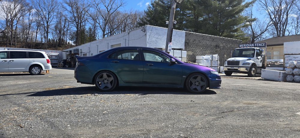 Green sedan outside the shop, repaired in Schenectady, NY